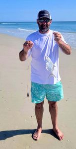 Florida Pompano catch displayed on Melbourne FL beach after successful fishing trip