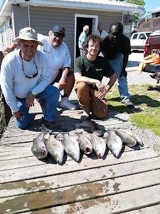 Three people fishing at a cross street location