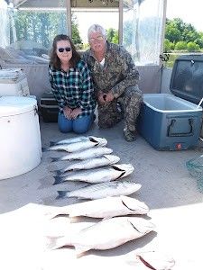 Two people fishing at a cross street location