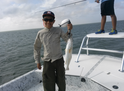 Angler holding a 15-inch fish in Port Isabel