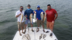 4 anglers fishing at Port Isabel