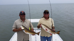 Two anglers fishing with rods in Port Isabel
