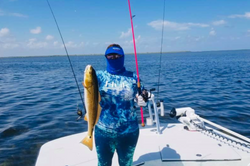 One fisherman catches a fish in Port Isabel