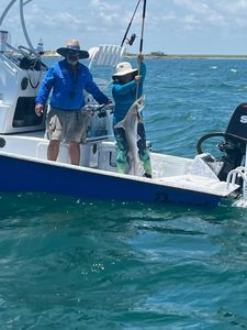 Two people fishing at Port Isabel