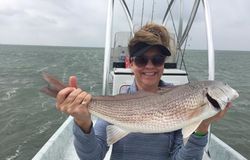 Angler catching a redfish in Port Isabel