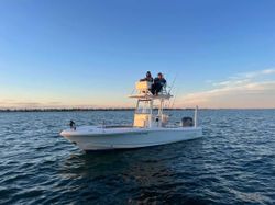 Fishing boat with tower on calm water in Milford CT during golden hour
