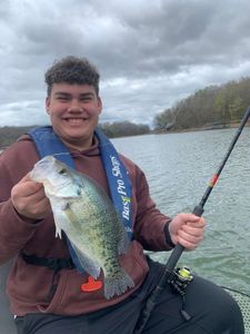 Big smile with fresh crappie catch on the lake.