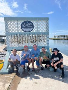 Successful speckled trout fishing trip at Bluff's Landing Marina in Corpus Christi Texas with multiple fish displayed