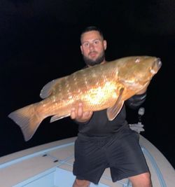A lone angler fishing in FL, catching a 30-inch big fish