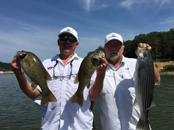 Two people catching striped bass and smallmouth bass in TN
