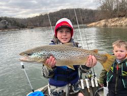 Angler catching a rainbow trout in Tennessee