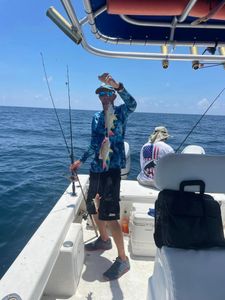 Angler with a 12-inch fish at Fort Myers Beach