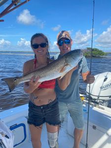 A fisherman holding a large redfish in Florida