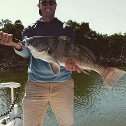 Angler with a black drum fish in FL