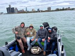 Four anglers with a big 24-inch fish caught in MI