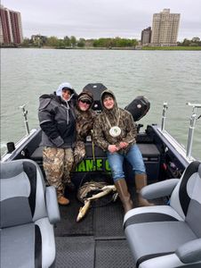Three people enjoying a fishing trip in MI