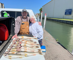 Two anglers with their catch of two big fish in Detroit