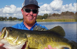 A fisherman holding a 22-inch fish in Kissimmee