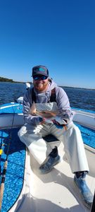 A fisherman holding a 13-inch fish on Johns Island