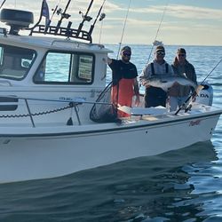 All happy onboard as we caught a Striped Bass.