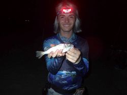 Single fisherman reeling in catch in NJ