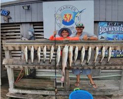 Successful redfish fishing trip display at Corpus Christi TX marina with multiple fish catch