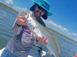 A fisherman holding a 17-inch fish in TX
