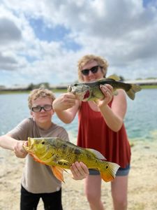 Two people fishing on a sunny day in Miami