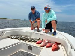 Successful fishing trip in Gulf Shores AL showing fresh catch on boat deck