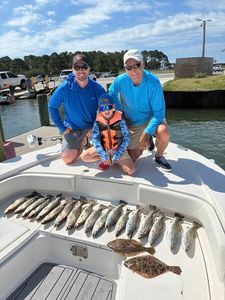 Successful fishing trip in Gulf Shores AL with mixed species catch displayed on boat deck