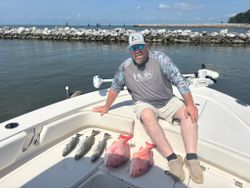 Successful fishing trip in Gulf Shores AL showing speckled trout and red snapper catch on boat deck