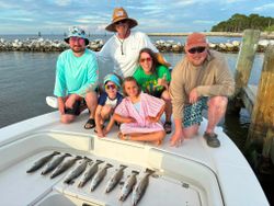 Successful speckled trout fishing trip in Gulf Shores AL with multiple fish displayed on boat deck
