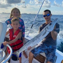 3 anglers with a big 27-inch fish caught on cruises and fishing trip in FL