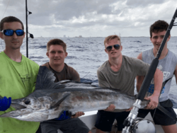 A group of 4 people fishing on the water in Florida