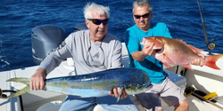 Two anglers holding large fish in West Palm Beach