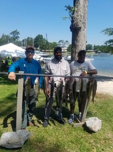 3 people fishing with 2 fish in Gaston