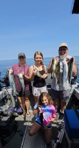 Family smiles, full box! Salmon and lake trout hauled aboard.