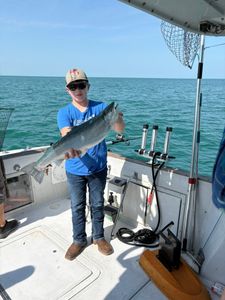 Angler with fishing rod enjoying the outdoors in Oswego