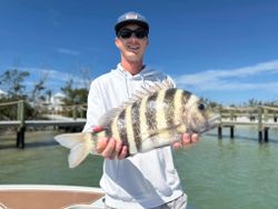 Holding a sheepshead catch under clear skies.