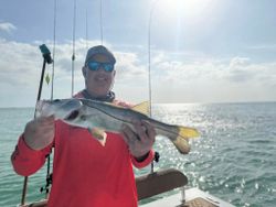 Showing off a snook catch under sunny skies.