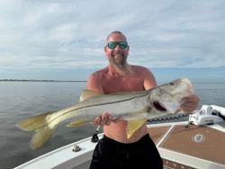 A fisherman holds a snook fish in FL
