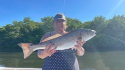 Angler with a large redfish caught in FL