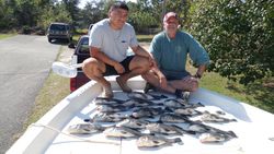 Two people fishing at Oak Island