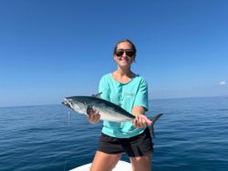 A fisherman holding a little tunny fish in Beaufort