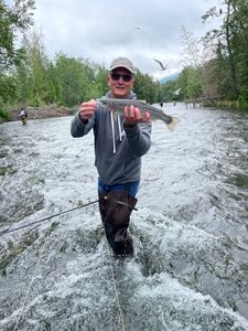 A person fishing for a rainbow trout in North Carolina