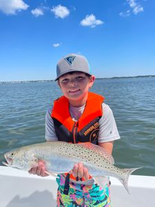 Angler catching a spotted weakfish in North Carolina