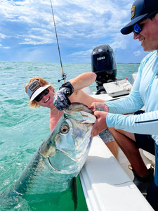 Angler holding a fishing rod against the scenic backdrop of Sarasota