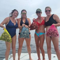 Three fishing enthusiasts reeling in the catch of the day at Crawfordville