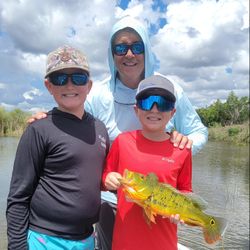 3 people fishing on the water in FL