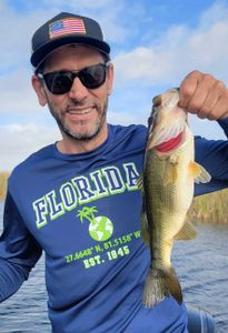 A fisherman catching a largemouth bass in Fort Lauderdale